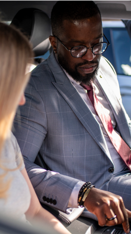 Customer and salesperson sat inside car