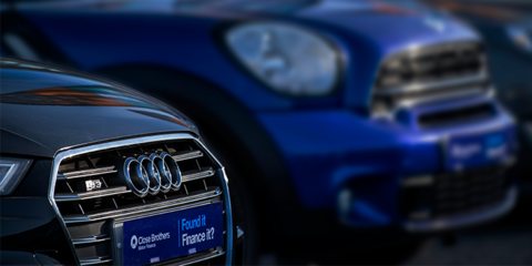 Two cars on a dealership forecourt